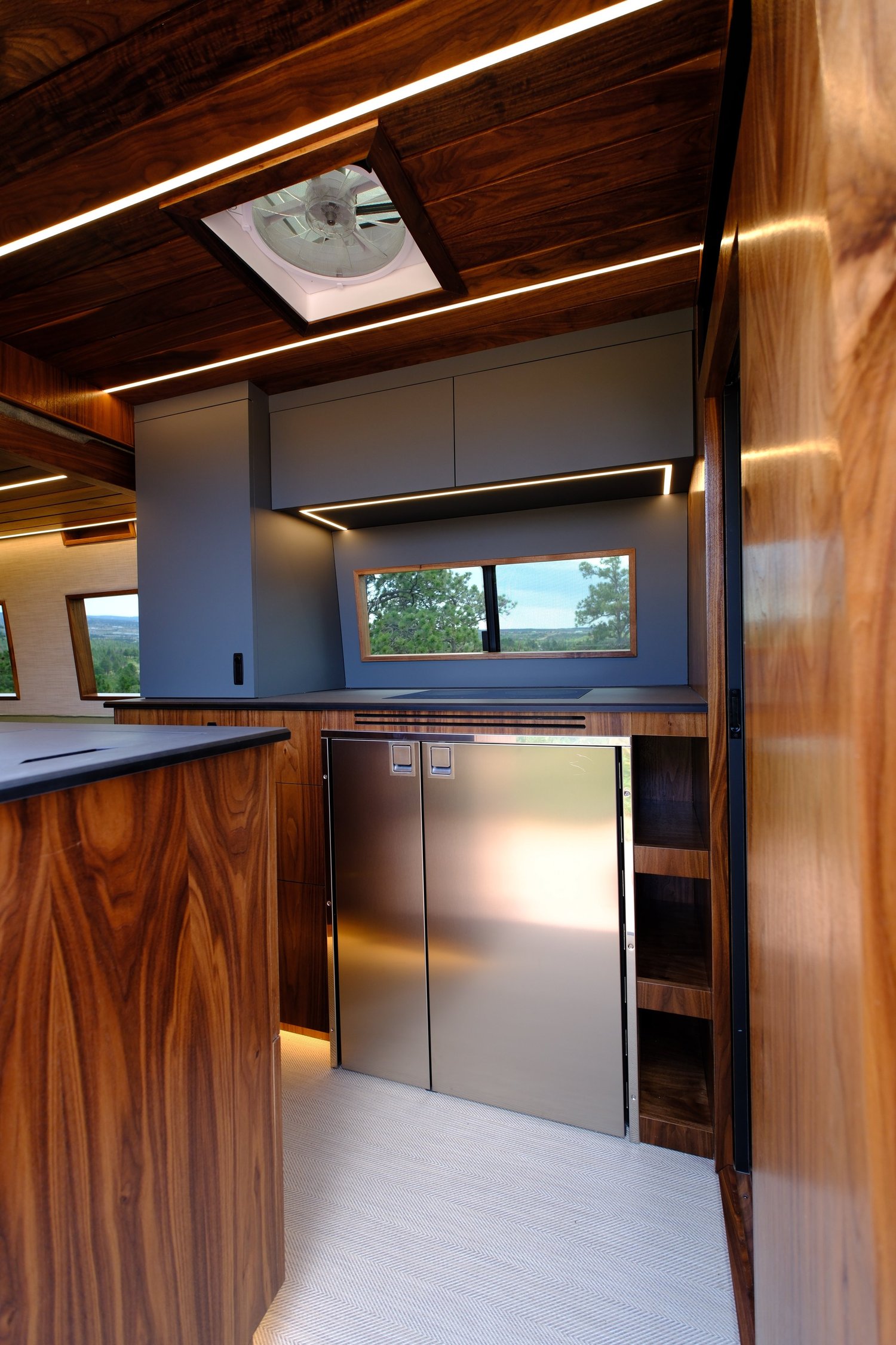 Rich wood cabinetry, matte upper cabinets and integrated ceiling lighting in the Bourbon custom build.