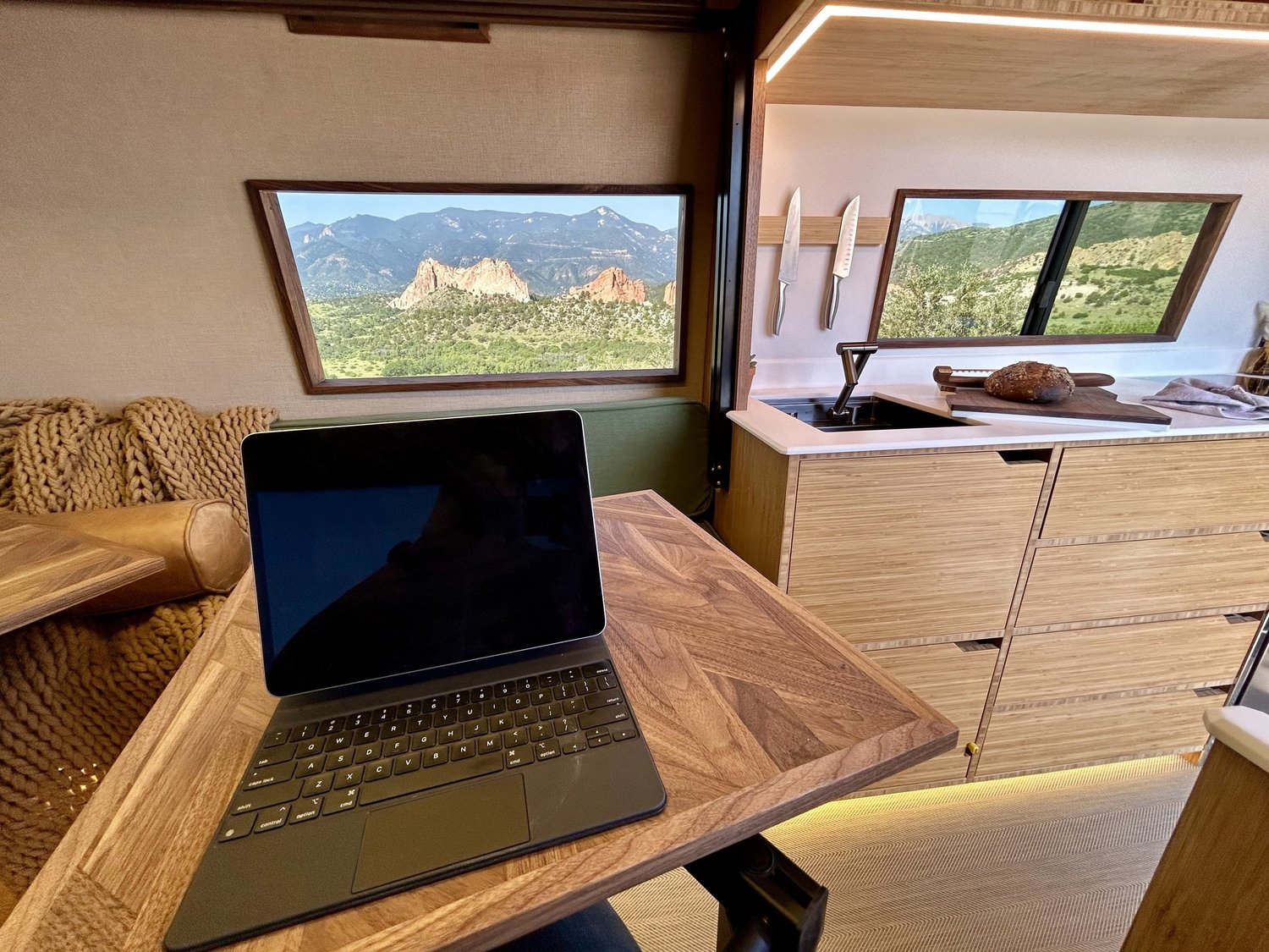 Forest dinette table beside the kitchen and a landscape-view window