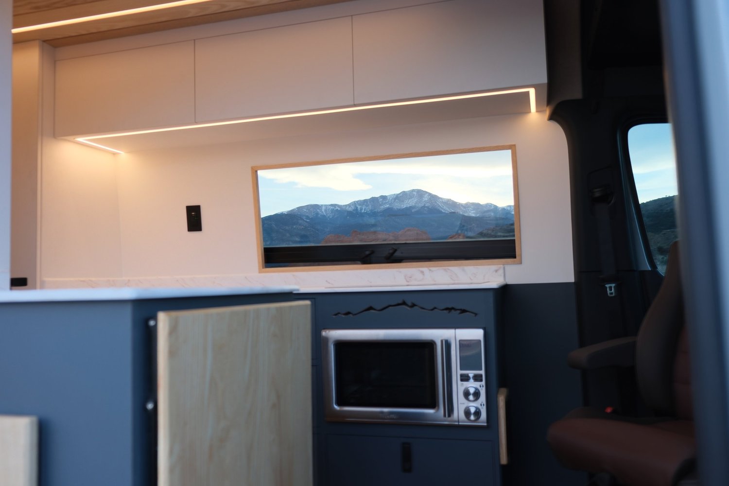 Midnight kitchen cabinetry with a mountain-view window