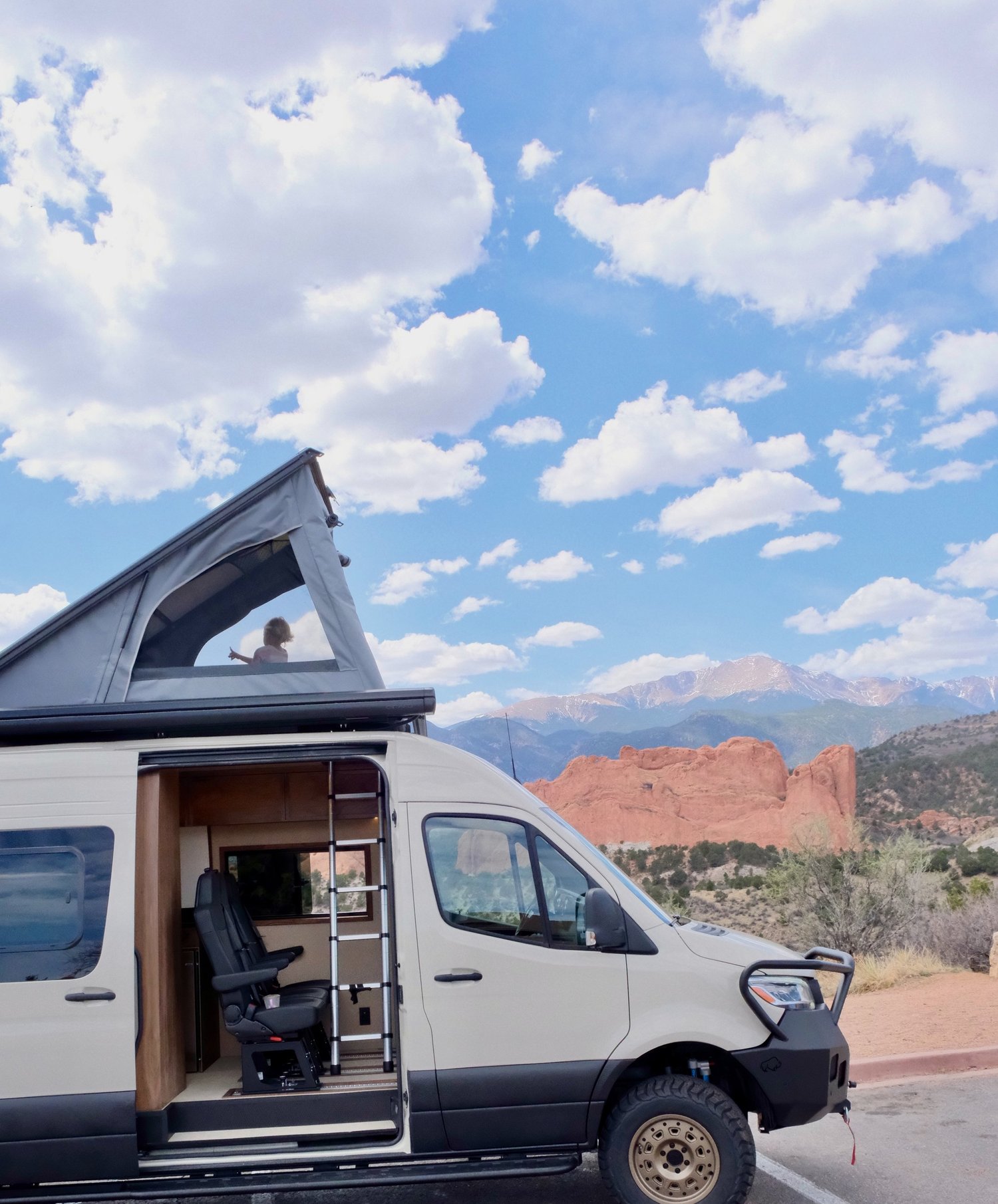 Timber with its pop-top raised against a mountain backdrop