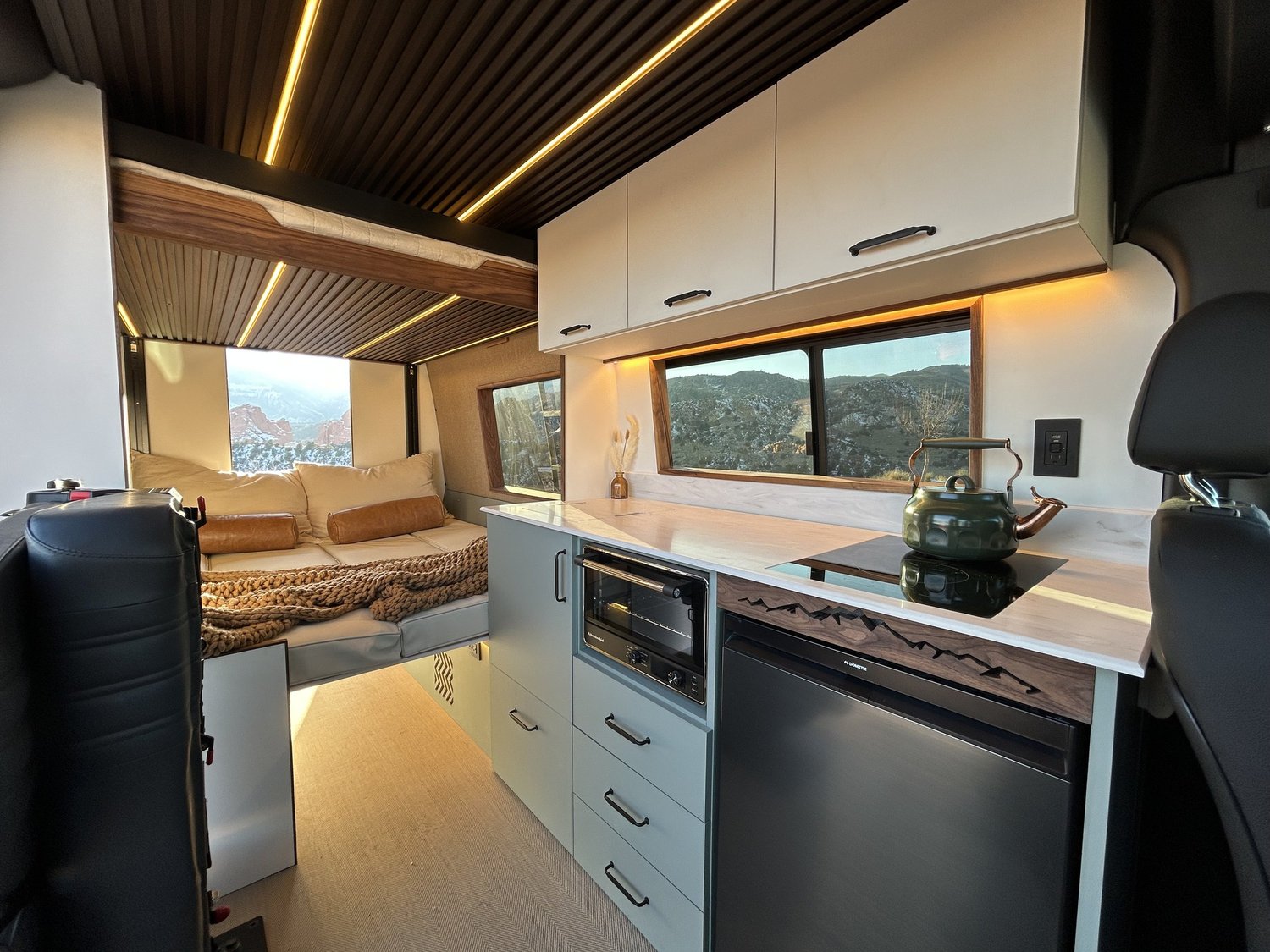 Twin Lakes interior with pale cabinets and a rear sleeping area