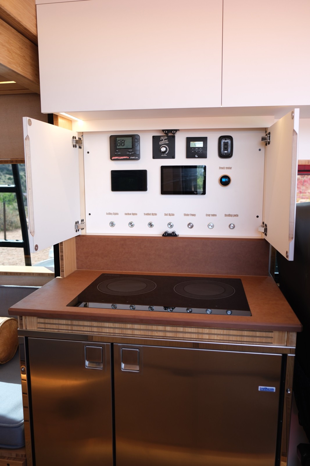 The Den control panel above the sink and refrigerator cabinet.
