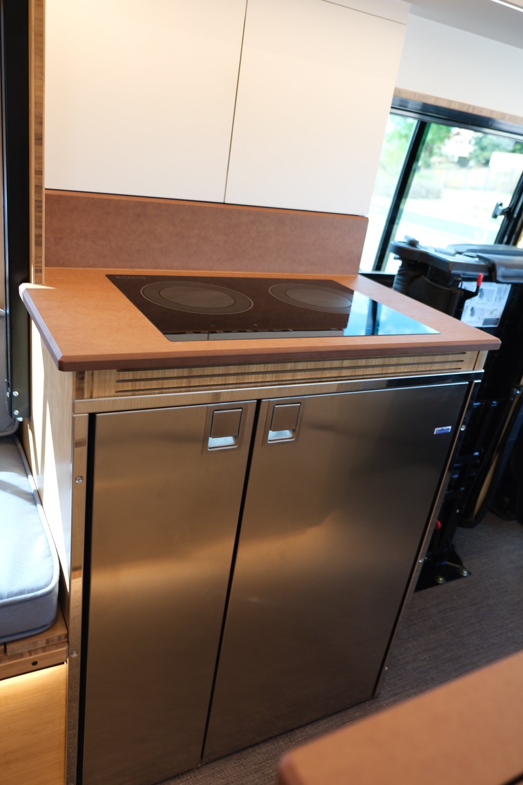 The Den galley with a covered sink and stainless refrigerator doors below the countertop.