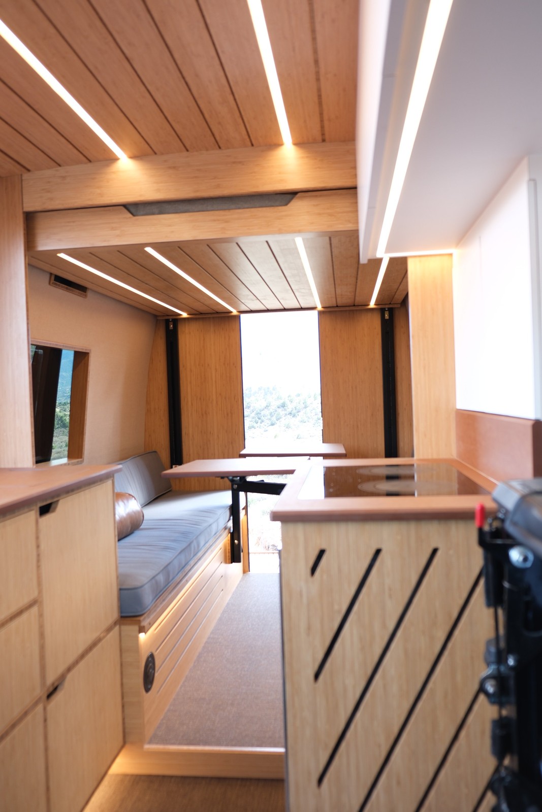 The Den interior aisle between the galley and dining table, looking toward the rear.