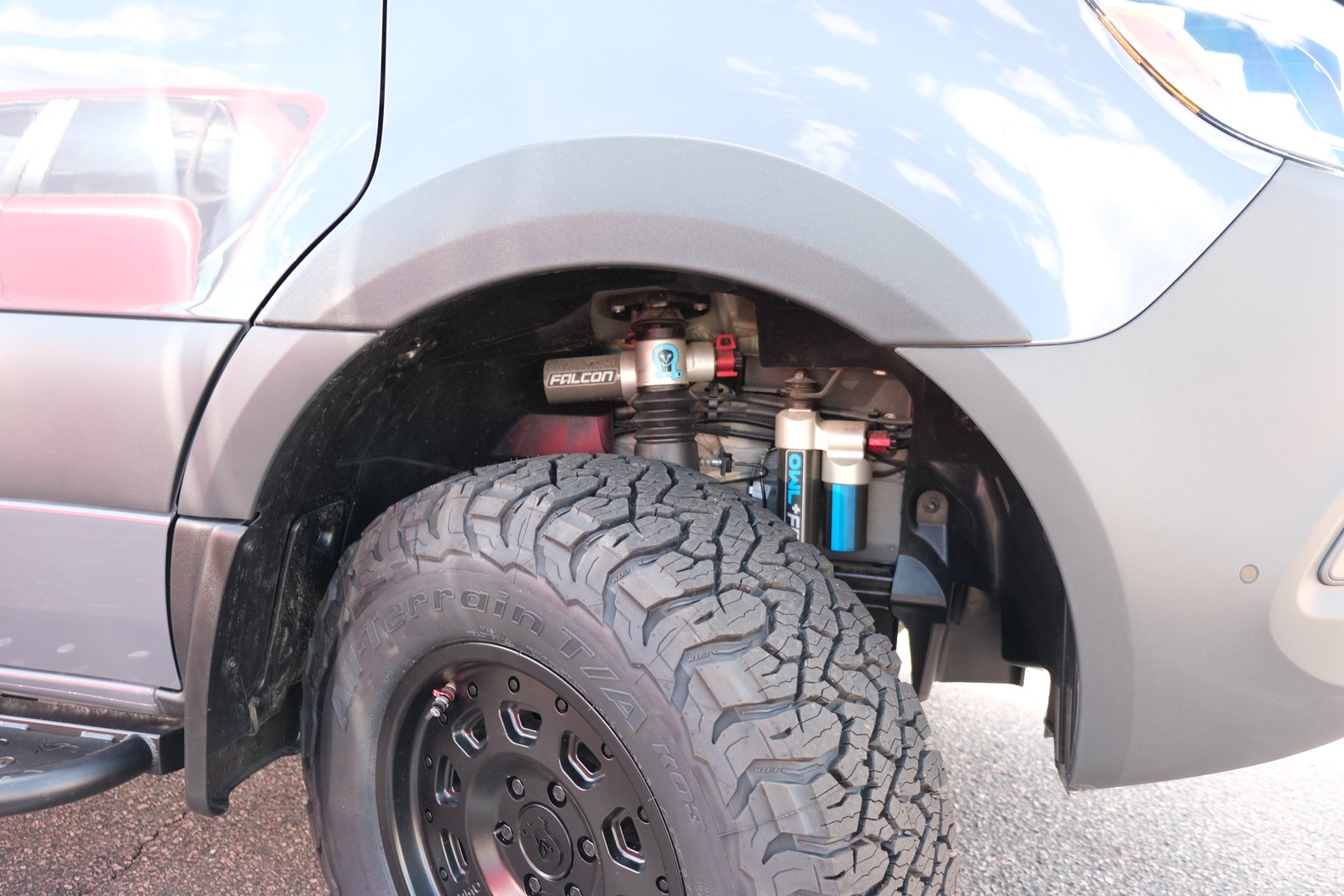 Close view of the Den front wheel and suspension components.