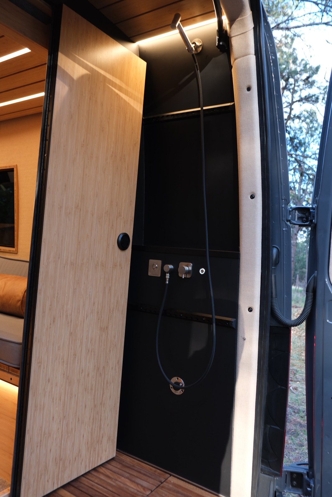 The Den rear wet bath with its hand shower and interior door.