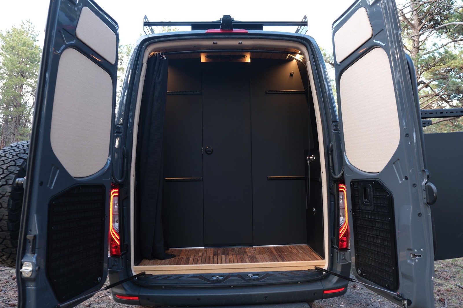 Wide view into the Den rear wet bath with both rear vehicle doors open.