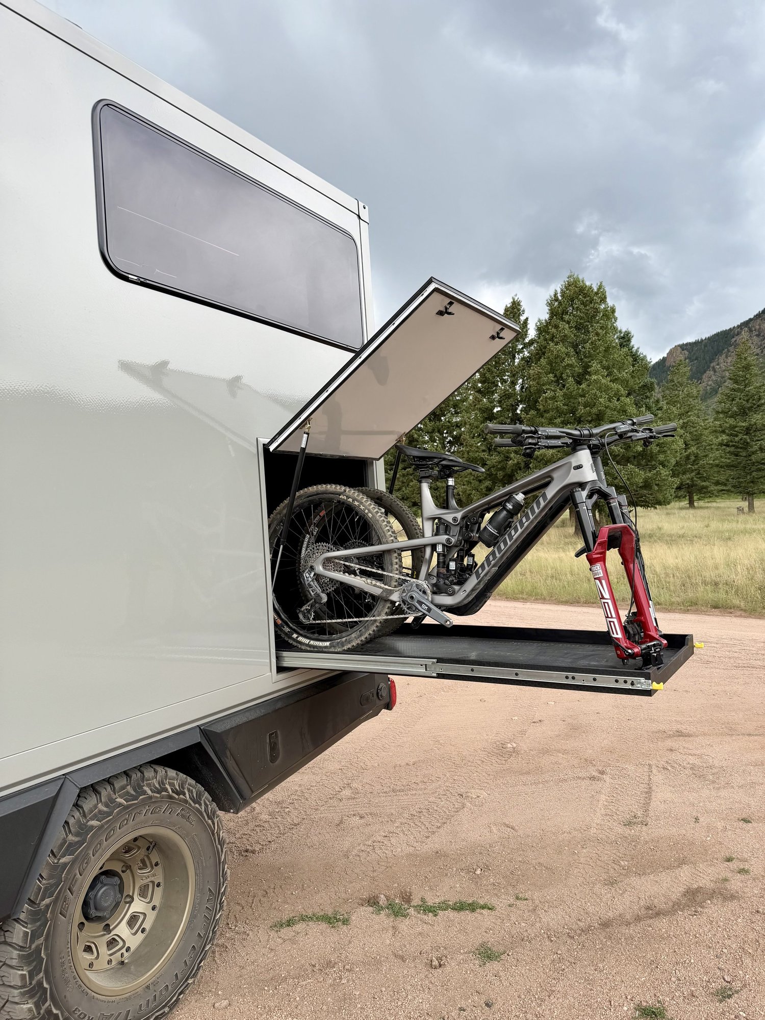 A mountain bike on the extended tray of The Nest’s exterior pass-through gear garage