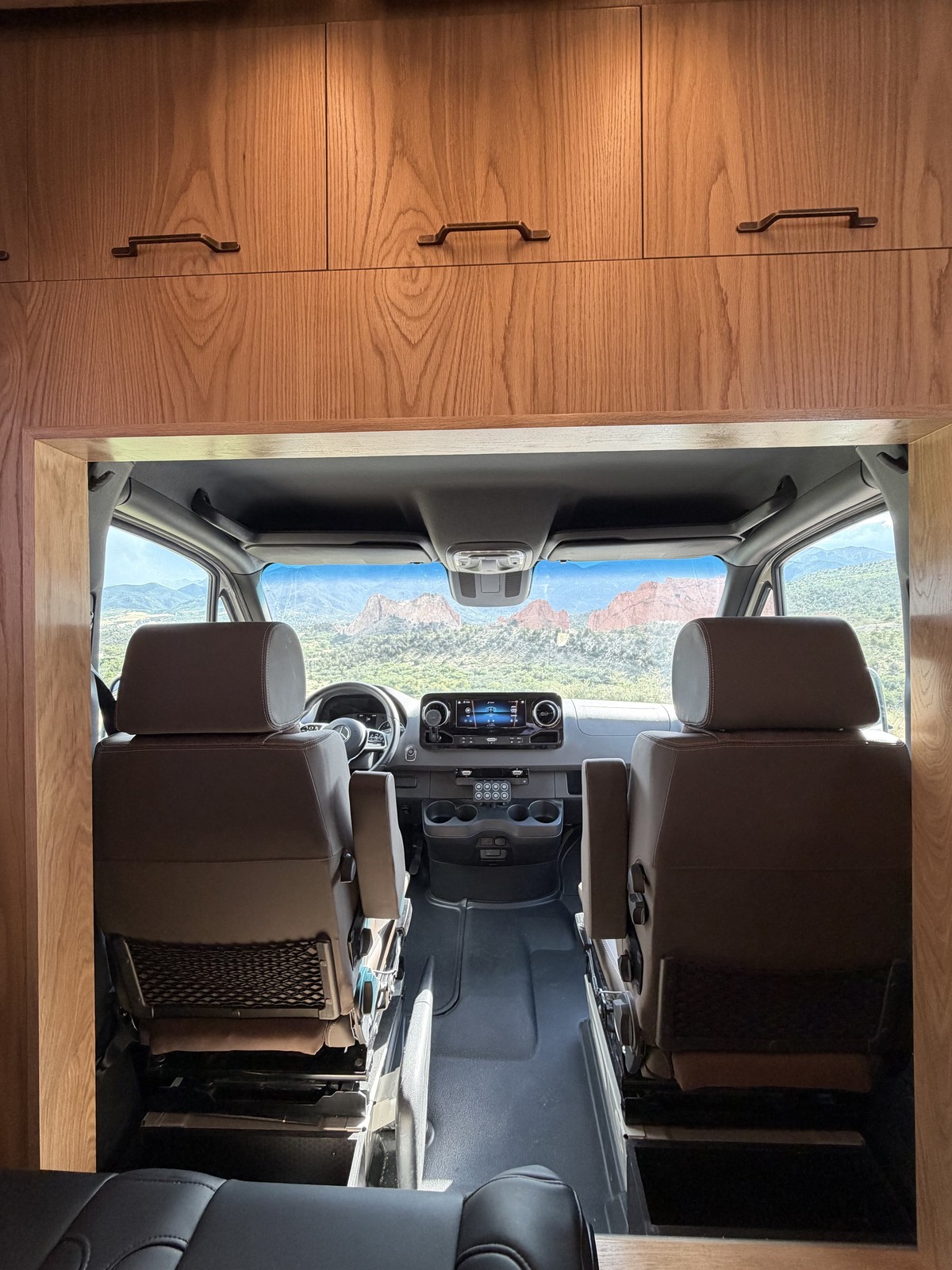 View through the Nest cab opening beneath overhead wood cabinetry.