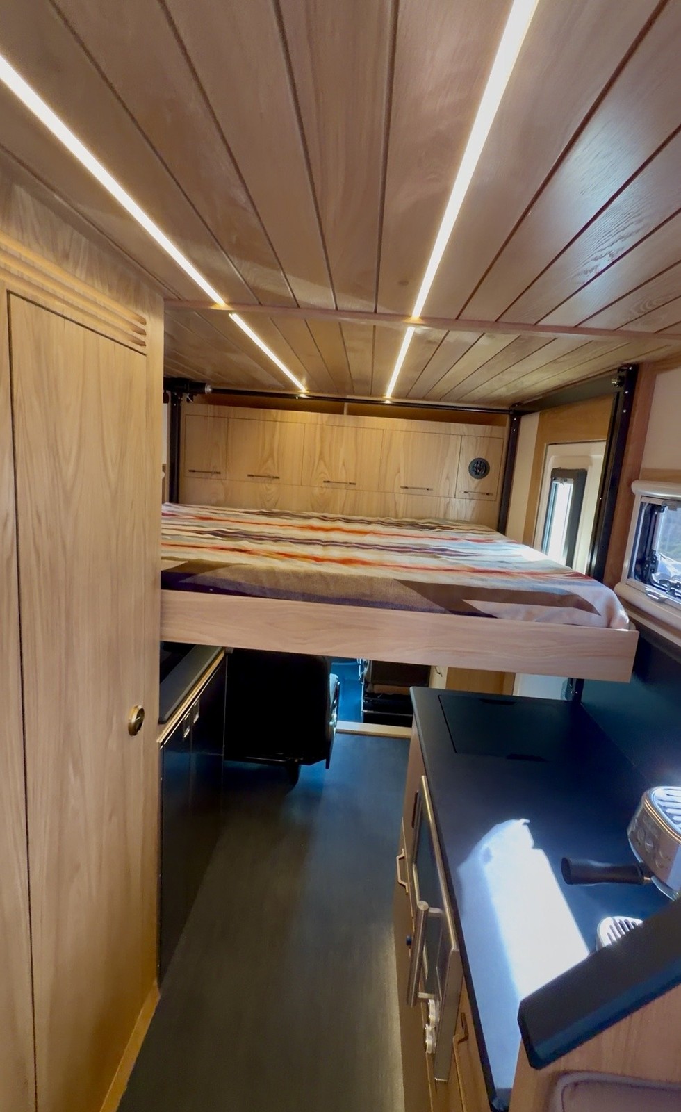 The Nest forward elevator bed lowered above the passenger seating.