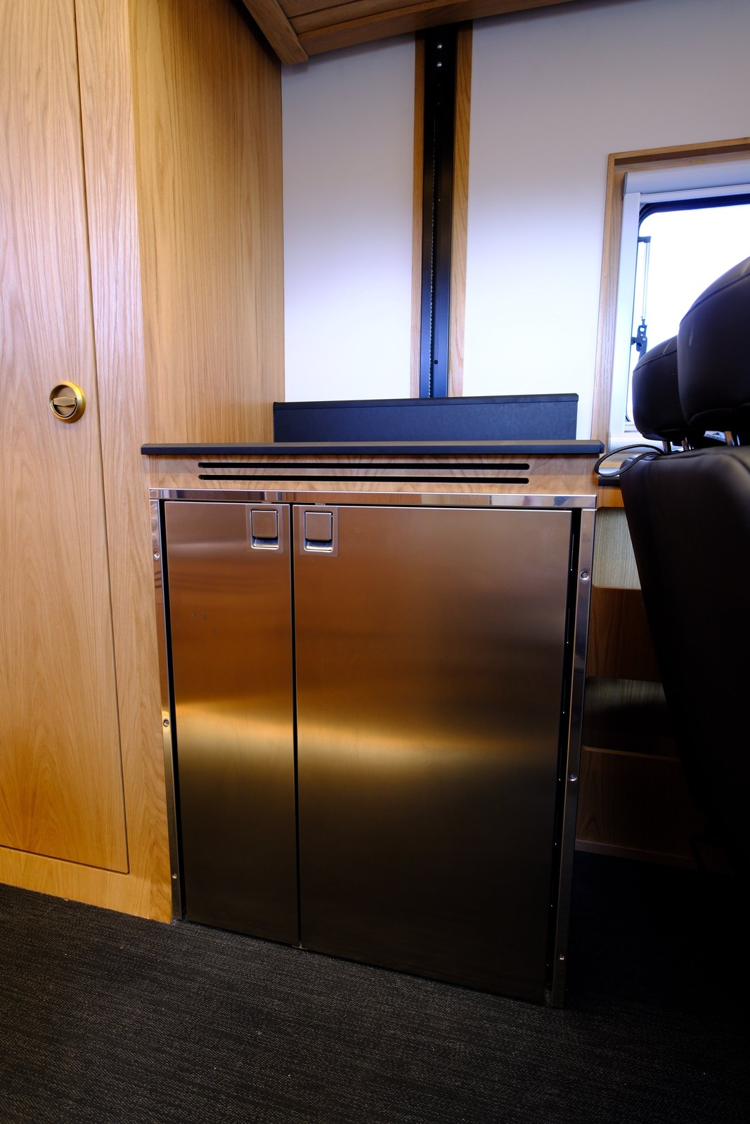 Closed stainless refrigerator doors beneath the Nest countertop.