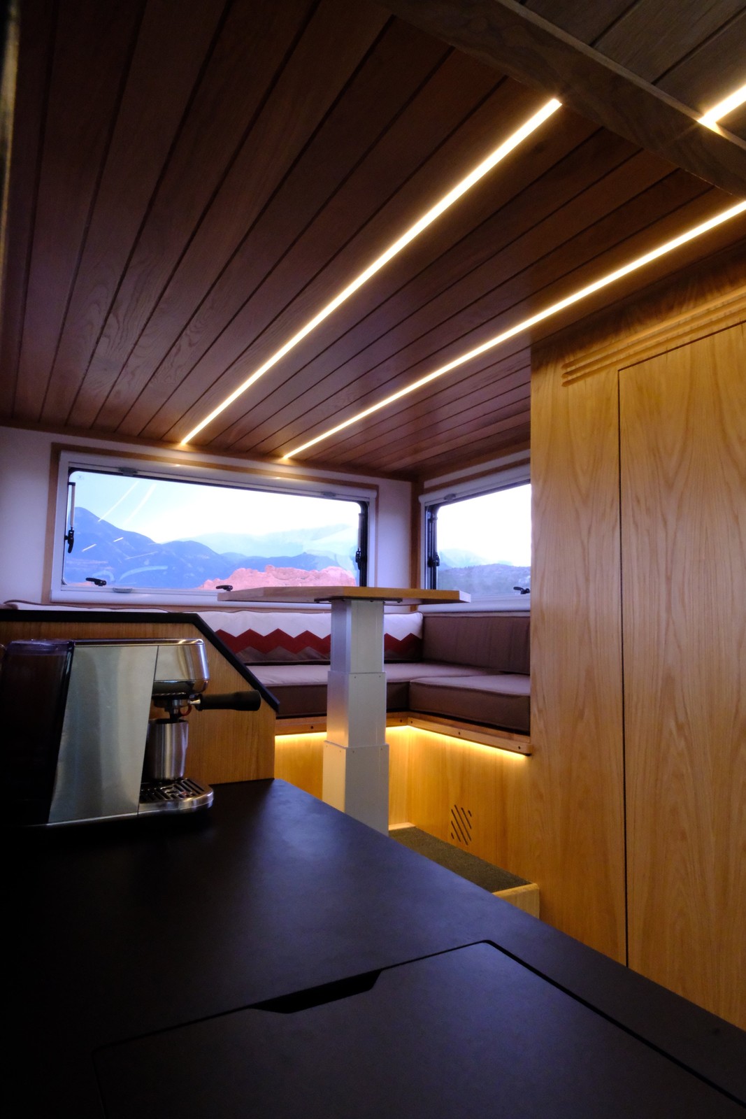 View across the Nest galley countertop toward the rear dinette and bathroom.