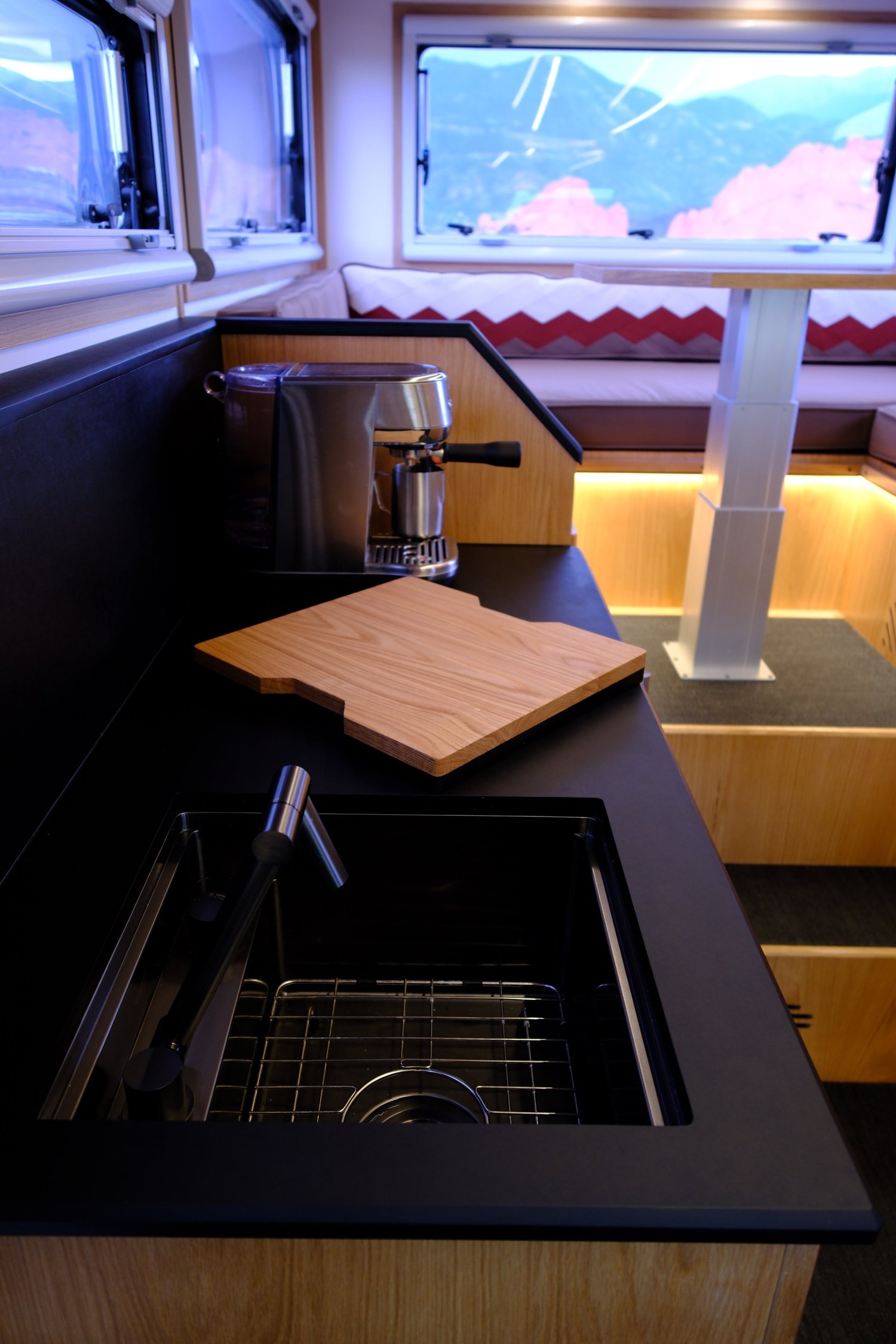 The Nest galley with an open sink, cutting board and wood cabinetry.